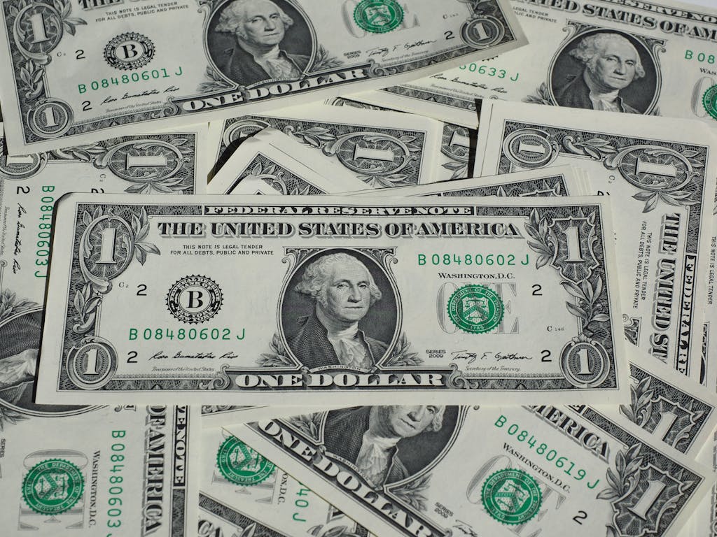 A detailed shot of a pile of U.S. one-dollar bills showcasing currency and finance concepts.