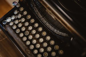 Detailed close-up of vintage typewriter with round keys, showcasing retro design.