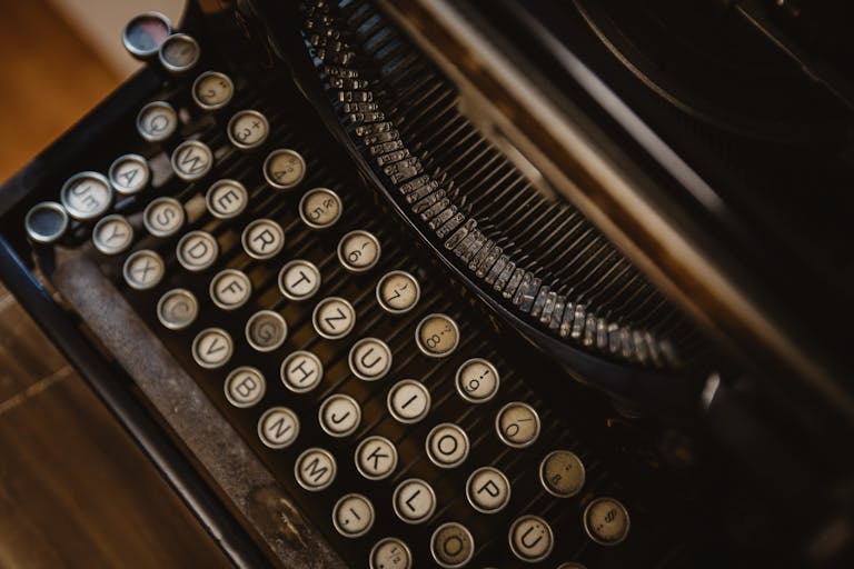 Detailed close-up of vintage typewriter with round keys, showcasing retro design.